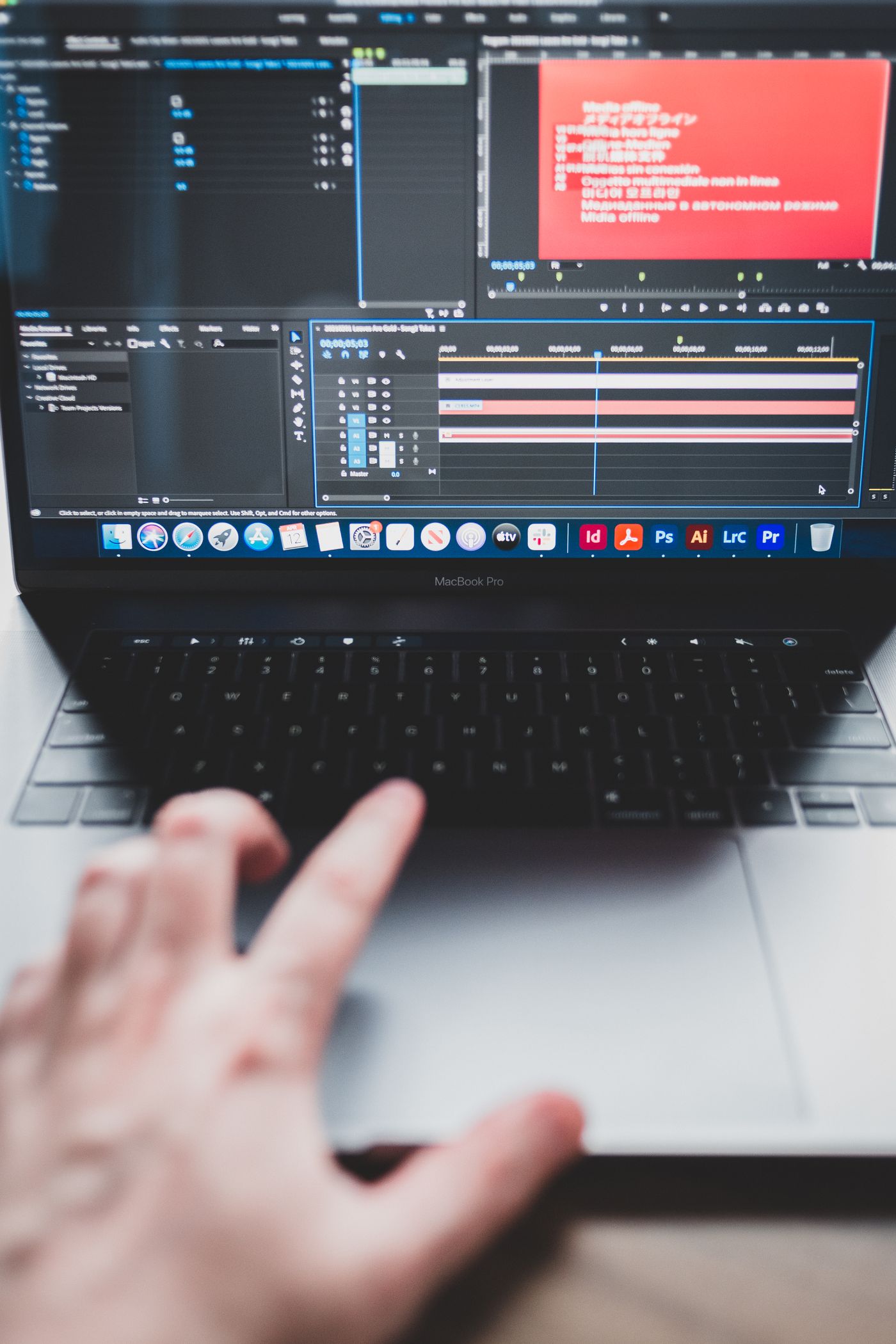 A close view of a laptop screen and trackpad during creative work